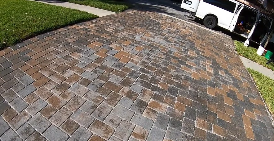 Restored, richly colored paver driveway after pressure washing in West Palm Beach
