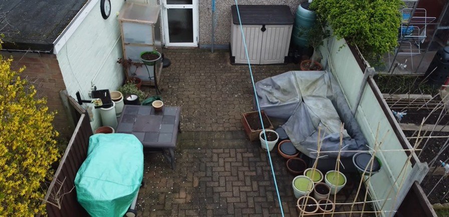 Dirty back patio before pressure washing