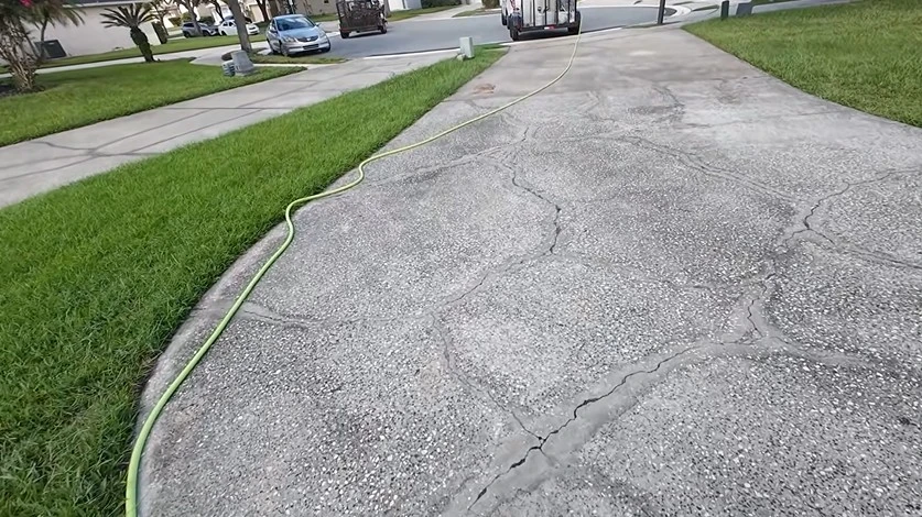 Dirty driveway before pressure washing in West Palm Beach