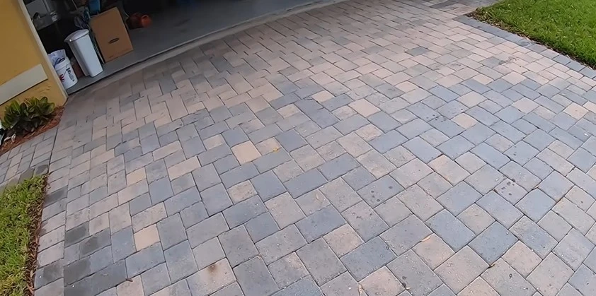 Dull, stained paver driveway before pressure washing in West Palm Beach