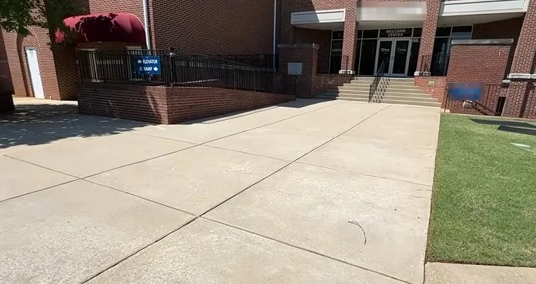 Clean concrete walkway at a commercial building entrance after pressure washing